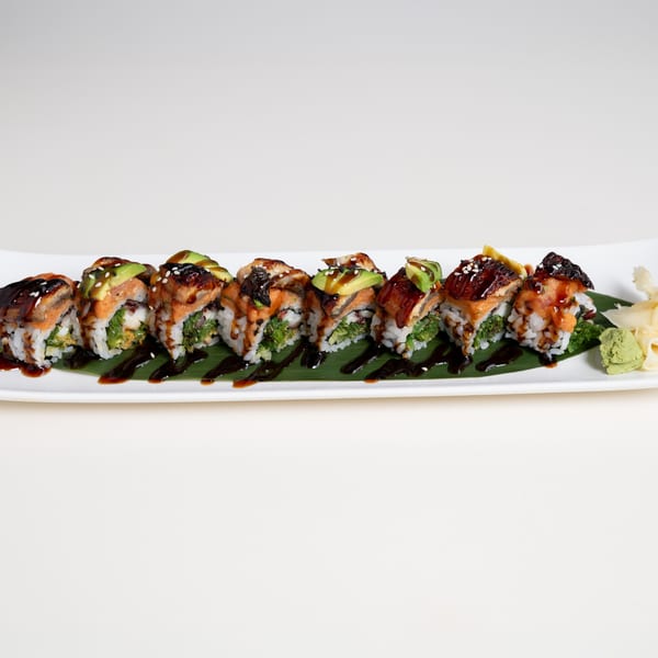 Seiko Japanese Restaurant's sushi roll with eel, avocado, and sauce, served on a banana leaf.