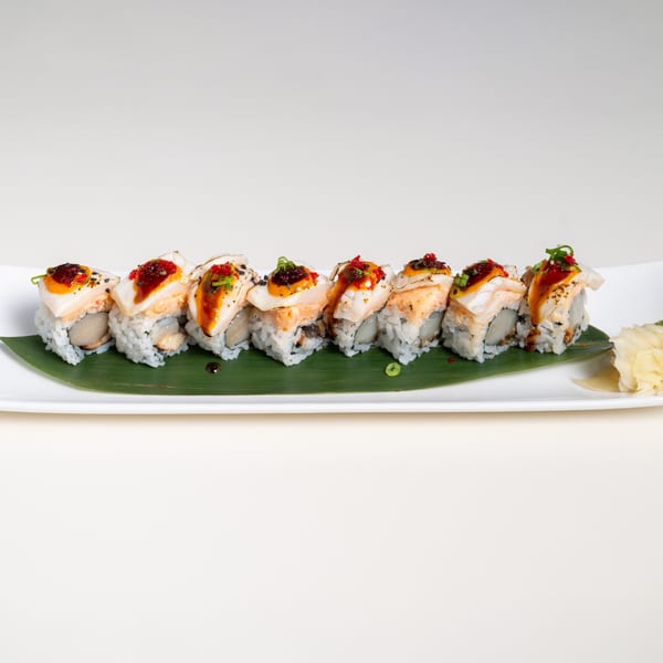 Seiko Japanese Restaurant's sushi rolls with white fish, orange sauce, and red caviar on a banana leaf.
